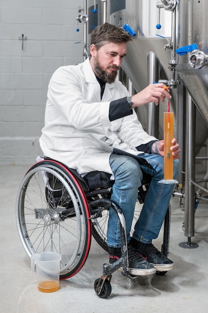 Person with disability who uses a wheelchair working at craft beer factory