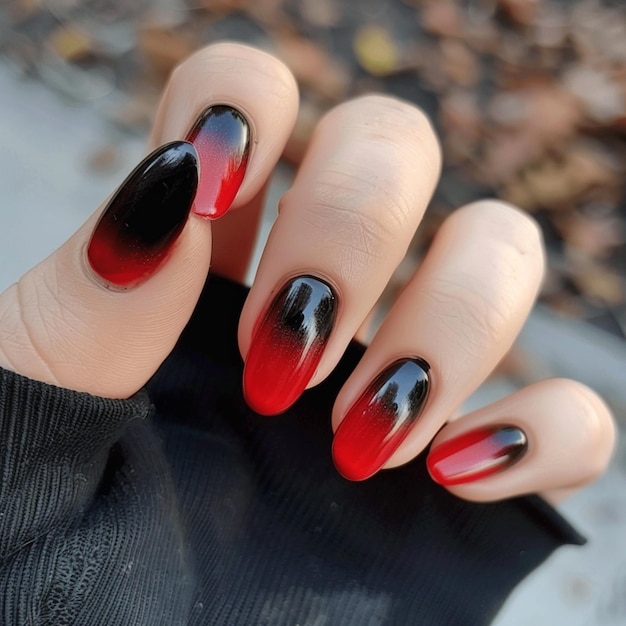 a person with red nails that has a black top that says quot b quot on it