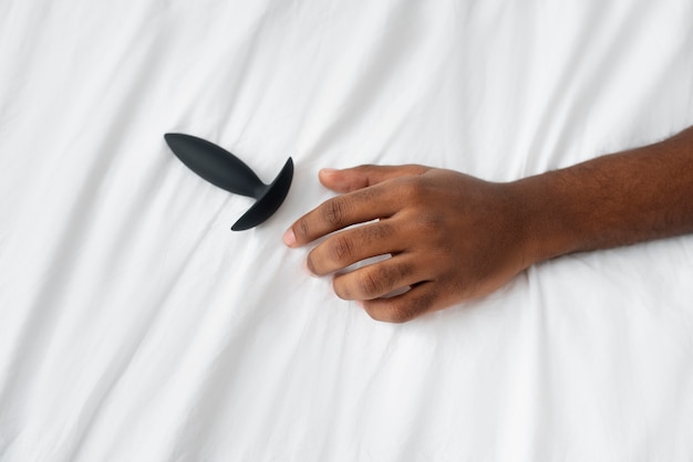 Person with sexual toy in bed