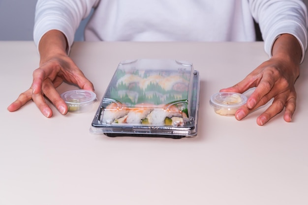 Person with sushi platter delivery fast food