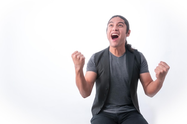 Person with white background man making gestures he is happy for a victory and with clenched fists he celebrates looking up he is very happy because he won something