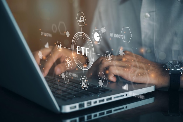 Person working on computer with icons of ETF Exchange traded fund stock market trading investment financial concept