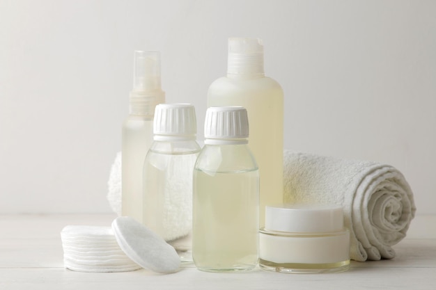 Personal hygiene products. Body care cosmetics. White bottles and vials on a light background. SPA. Relax.