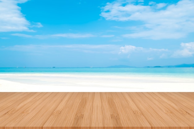 Perspective brown wooden table on top over blur sea background. Beautiful sea in Thailand.