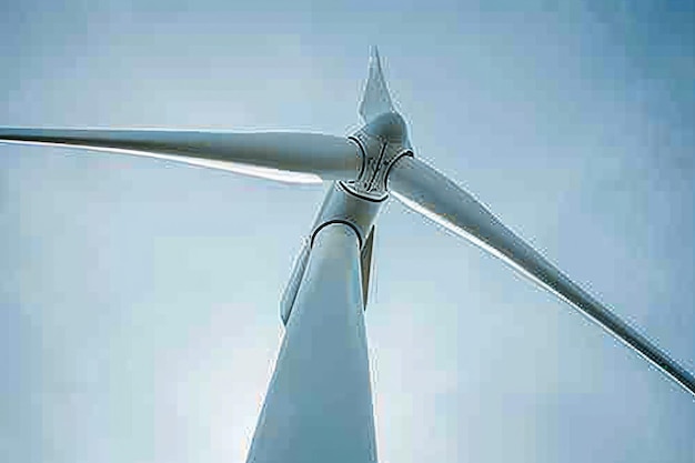 Photo perspective shot from the base of a wind turbine looking up creating a sense of awe and scale about green energy