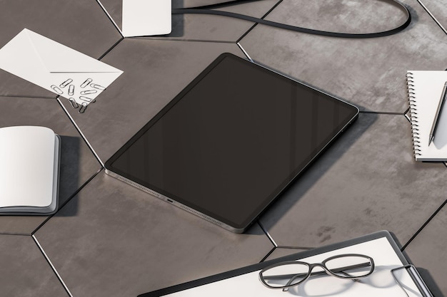 Perspective view on blank dark modern digital tablet screen with place for your logo or text on concrete tiles surface among office tools and papers 3D rendering mock up