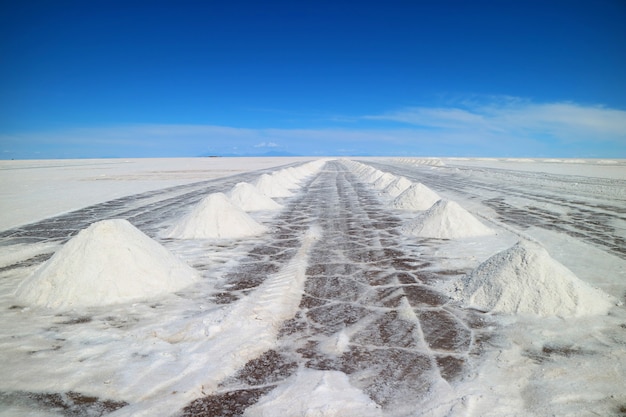 Perspective view of drying salt piles on Uyuni salt flats or Salar de Uyuni, Bolivia