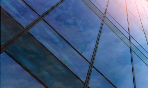 Perspective view of modern futuristic  glass building abstract background. Exterior of office glass building architecture. Reflection in transparent glass of business building.