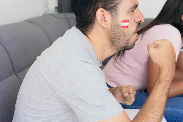 Peru fans watching a soccer game on television at home