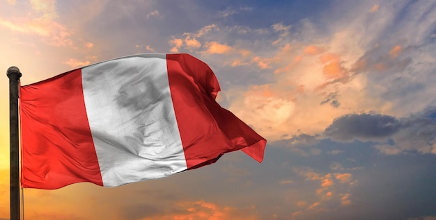 The peru waving flag and sky background.