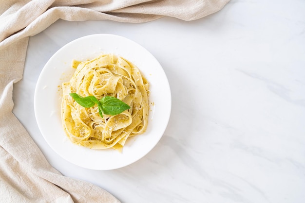 pesto fettuccine pasta with parmesan cheese on top - Italian food style