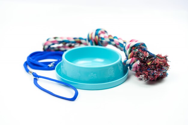 Pet bowl and leashes with toy on isolated white