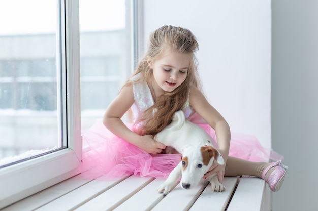 Pet and children concept - Child with dog Jack Russell Terrier at home.