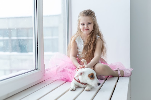 Pet and children concept - Child with dog Jack Russell Terrier at home.