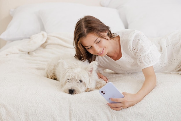 Pet love concept girl at home holding a dog in her arms