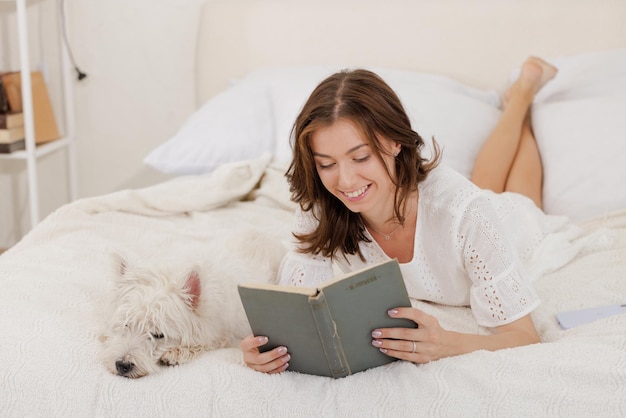 Pet love concept girl at home holding a dog in her arms