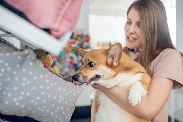 In a pet shop. A smiling girl choosing animal accessories in a pet shop