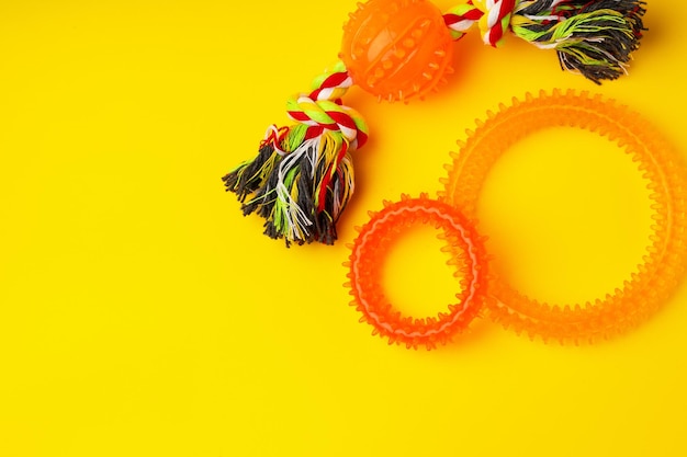 Pet toys on yellow background studio shot