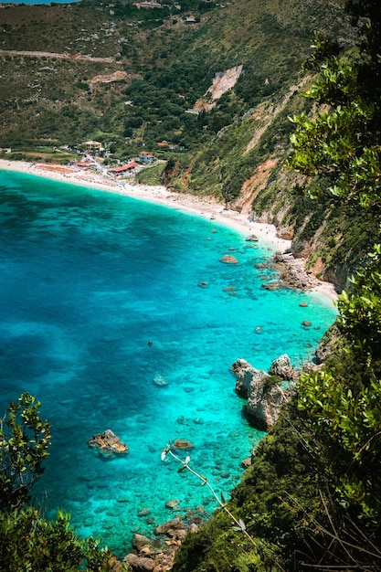 Petani beach on hot sunny summer day View to Petani bay with transparent and crystal clear blue azure mediterranean sea water in beautiful lagoon Kefalonia island Greece