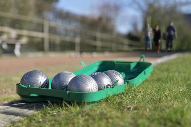 Petanque balls in a box on the grass