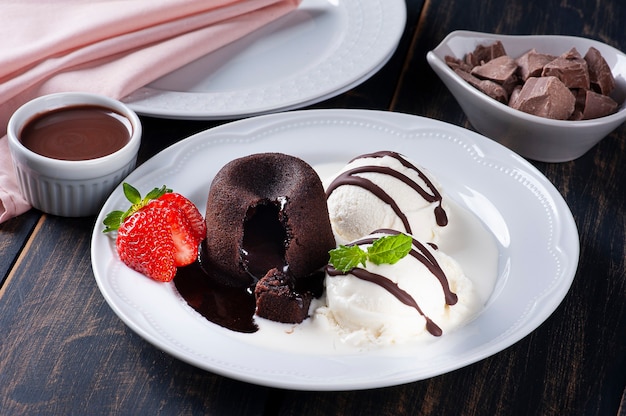 Petit Gateau with ice cream and strawberry on white plate