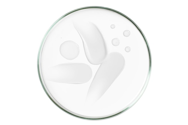 Petri dish isolated on empty background A smear of cosmetic cream in a Petri dish