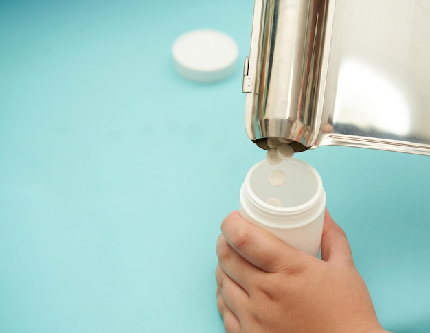 Pharmacist pour pills into bottle