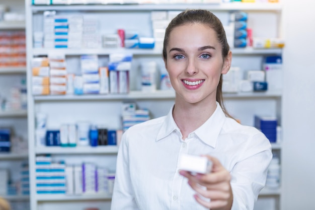 Pharmacist showing a medicine in pharmacy