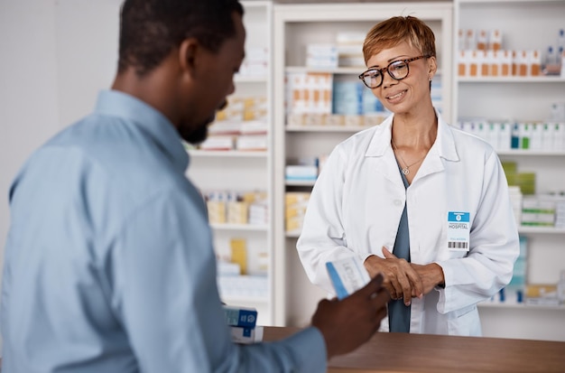 Pharmacist woman talking to customer about medicine information or advice on pills box Black man with pharmacy clinic or store worker for pharmaceutical medical and health counter service