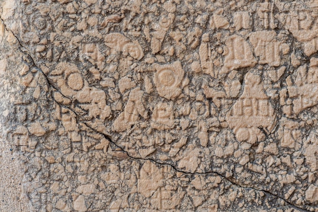 Phaselis, Turkey - November 08, 2021: half-erased antique Greek or Roman inscription on a stone