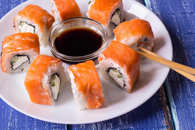 Philadelphia Maki Sushi made of Fresh Raw Salmon Cream Cheese and Cucumber with soy sauce