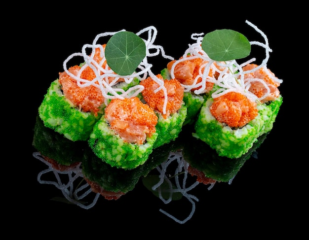 Philadelphia roll with green tobiko and salmon on glossy black background