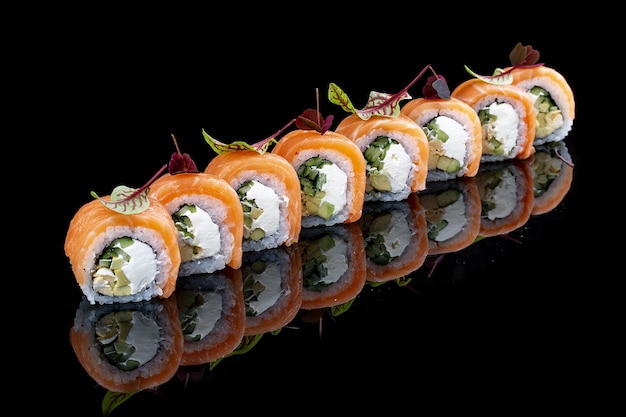 Philadelphia roll with salmon on glossy black background