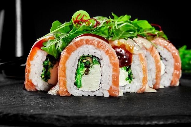 Philadelphia rolls with salmon eel cream cheese hiyashi served with unagi sauce and greens