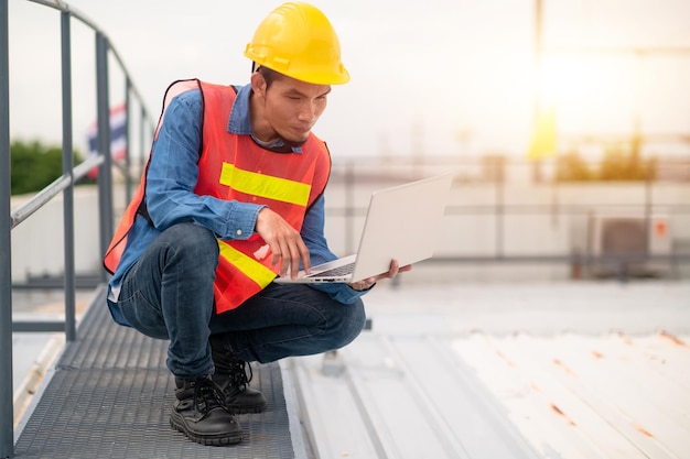 Philippines Asian man worker engineer working on rooftop factory plant