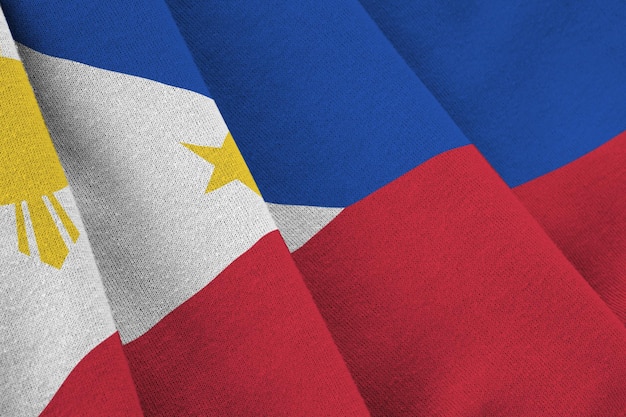 Philippines flag with big folds waving close up under the studio light indoors the official symbols