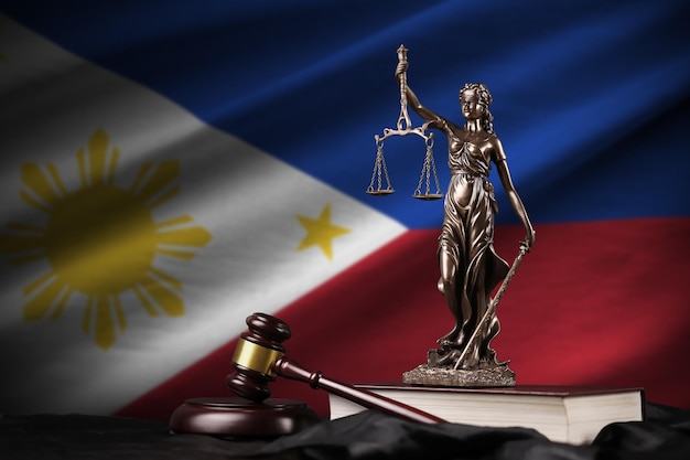 Philippines flag with statue of lady justice constitution and judge hammer on black drapery concept