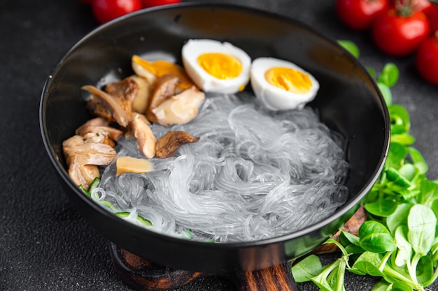 Pho Bo asian soup rice noodles funchose, egg, mushrooms meal food snack on the table copy space