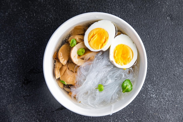 Pho Bo asian soup rice noodles funchose, egg, mushrooms meal food snack on the table copy space