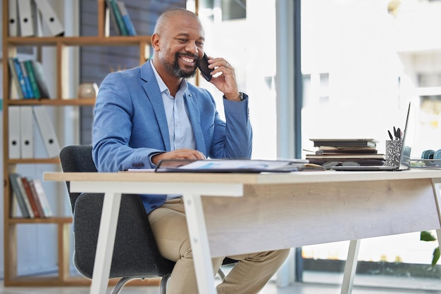 Phone call business and black man at office desk for corporate communication in company Mature entrepreneur mobile networking and talking on smartphone for sales deal negotiation and ceo contact