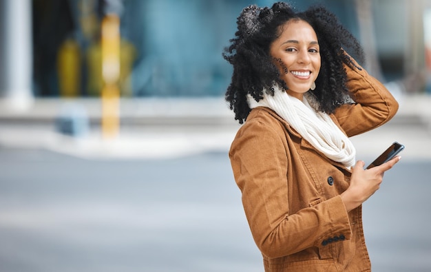 Phone city and portrait of black woman travel communication and social media networking on way to work Walking 5g technology and winter fashion person on smartphone in urban city street or road