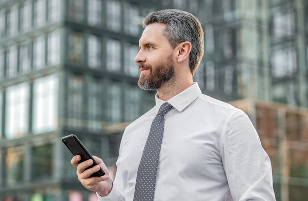 Phone communication of smiling businessman businessman with phone has communication