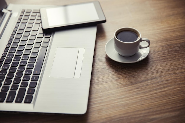 Phone on keyboard with coffee