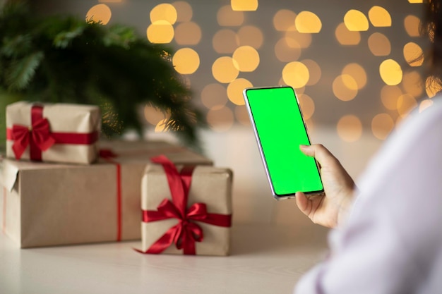 phone with green screen, the concept of online shopping for Christmas