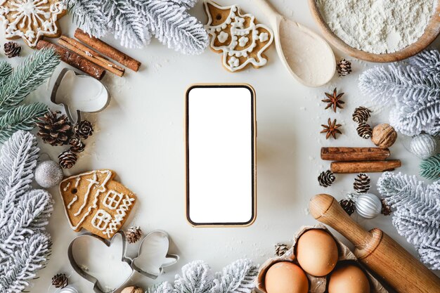 Phone with an isolated screen on the background of New Year's ingredients for cooking Place for your recipe