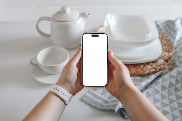 Phone with an isolated screen on the background of a set of dishes a place for your advertising