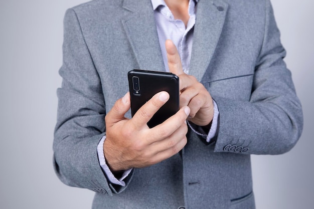 Phonemen hand holding texting using mobile on sofa at home