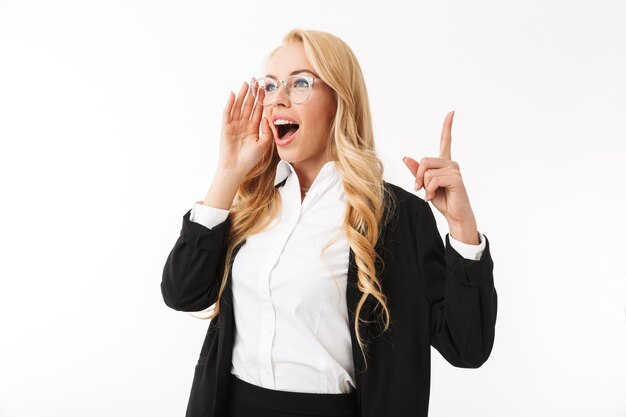 Photo photo of adorable businesswoman wearing office suit and eyeglasses smiling while looking aside isolated