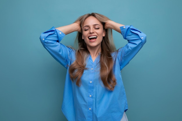 Photo of adorable young woman dreaming on blue background with blank space