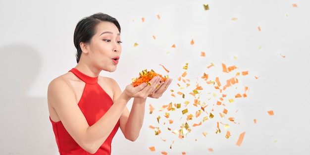 Photo of amazing lady blowing shiny confetti making fairy tale wear red dress isolated white background